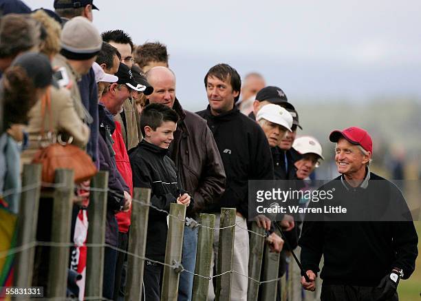 Actor Michael Douglas talks to the crowd on the 16th hole during the second round of the Dunhill Links Championships on the Old Course, September 30,...
