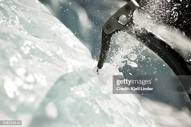 ice axe being plunged into ice wall - ice pick ストックフォト��と画像