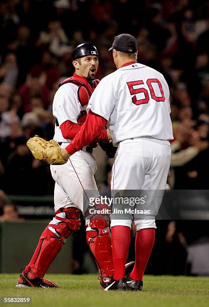 Catcher Jason Varitek of the Boston Red Sox celebrates with closing pitcher Mike Timlin after defeating the New York Yankees 5-3 at Fenway Park on...