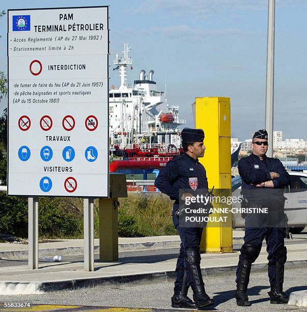 French police officers stand at the entry of Lavera's oil terminal to grant the access of the plant despite the strike of the dockers 1st October...