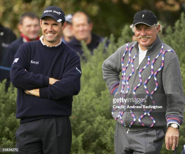 Padraig Harrington of Ireland and businessman Dermot Desmond share a joke while waiting to the play the 12th hole during the third round of the...
