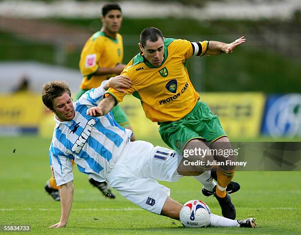 Dean Hammond of Brighton slides in on Andy Hughes of Norwich during the Coca-Cola Championship match between Brighton & Hove Albion and Norwich City...