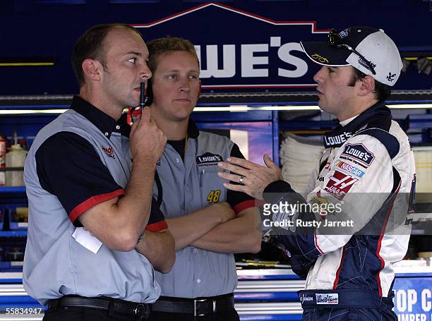 Crew chief Chad Knouse, works with Jimmie Johnson, driver of the Lowes Chevrolet, during practice for the NASCAR Nextel Cup Series UAW-Ford 500 on...