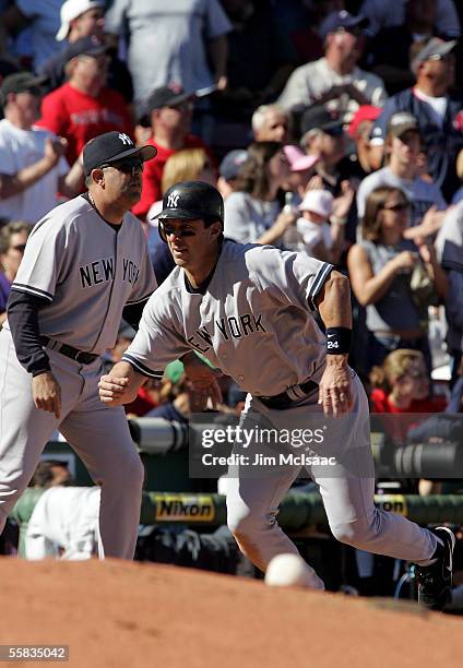 Tino Martinez of the New York Yankees tags up to score the fourth run on a sacrifice fly ball hit by John Flaherty in the second inning against the...