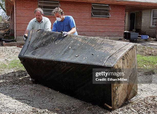 Daniel Mathews and his brother, Brent Mathews, move a couch out of their mother's flooded home in the Lakeview District October 1, 2005 in New...