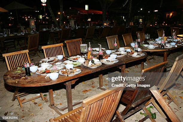 Empty tables, with food and drink on it, lie at Jimbaran Fish Cafes after a bomb blast on October 1, 2005 in Bali, Indonesia. Several explosions were...