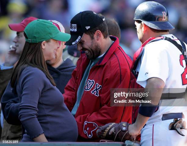 Actor Ben Affleck laughs with his wife, actress Jennifer Garner and catcher Doug Mirabelli of the Boston Red Sox as they attend the game against the...