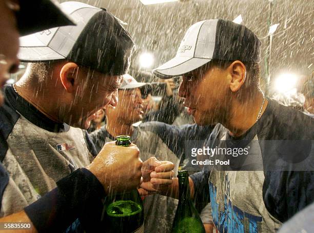 Alex Rodriguez and teammate Derek Jeter celebrate in the locker room after the New York Yankees clinched the AL East division title by defeating the...