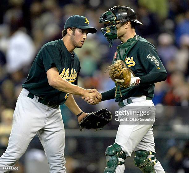 Closing pitcher Huston Street of the Oakland Athletics is congratulated by catcher Jason Kendall after getting the save in their win over the Seattle...