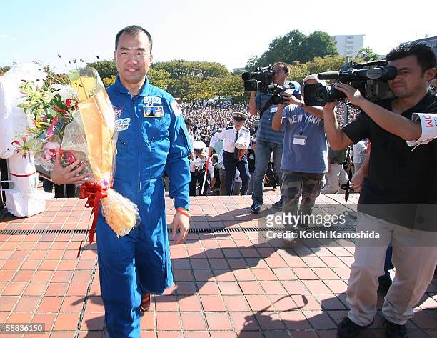 The Space Shuttle Discovery crew member Soichi Noguchi, of the Japan Aerospace Exploration Agency , waves to people as he parades in his home town of...