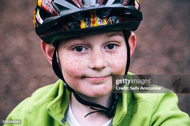 happy smiling boy wearing a bicycle helmet - cycling helmet stock pictures, royalty-free photos & images