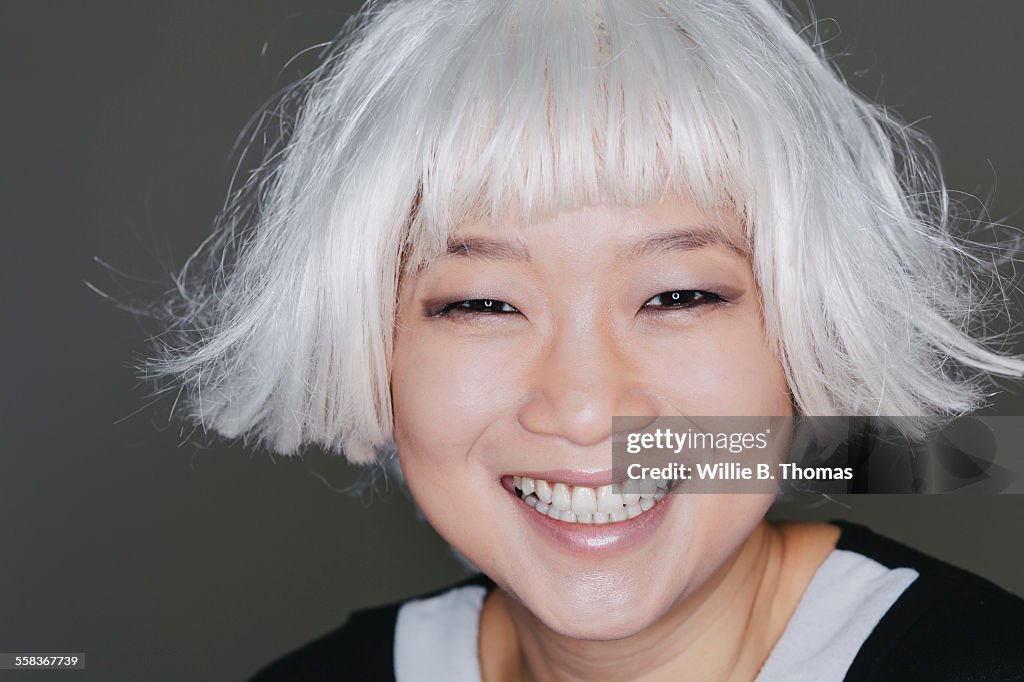Asian woman with platinum blond hair