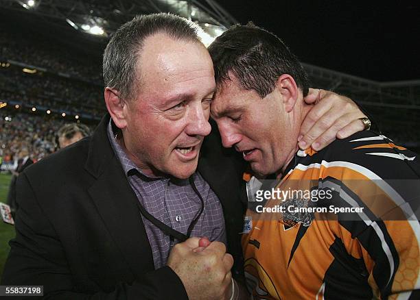 Tigers Coach Tim Sheens congratulates Mark O'Neill of the Tigers after winning the NRL Grand Final between the Wests Tigers and the North Queensland...