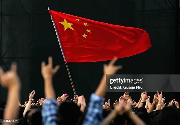 Chinas national flag is flown during a rock-and-roll festival to mark Chinese National Day on October 2, 2005 in Beijing, China. Various activities...