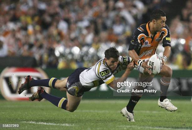 Benji Marshall of the Tigers is tackled by Josh Hannay of the Cowboys during the NRL Grand Final between the Wests Tigers and the North Queensland...