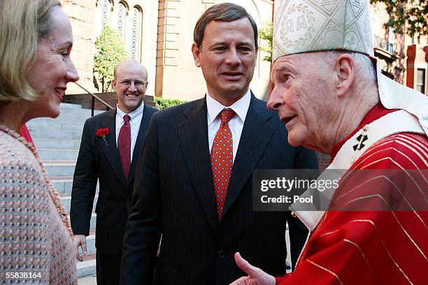 New Chief Justice John Roberts looks on as Cardinal Theodore McCarrick, Archbishop of Washington, speaks to Roberts' wife Jane after the 52nd Annual...