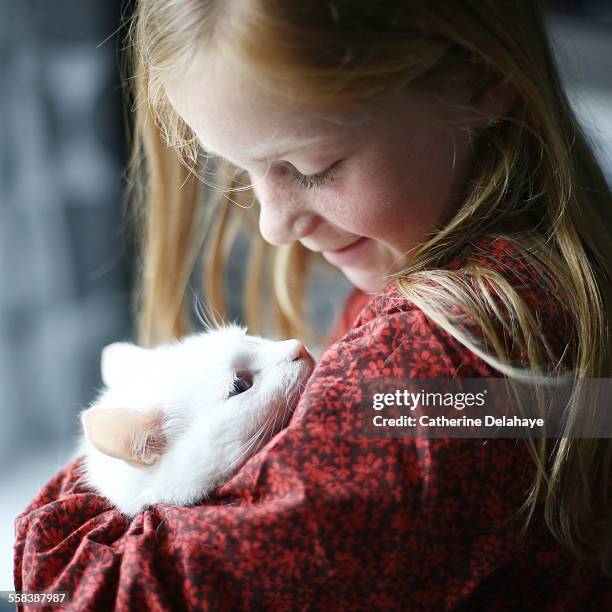 A girl cuddling her cat