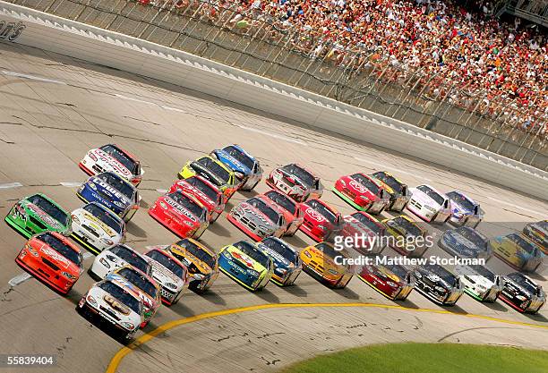 Tony Stewart, driver of the Home Depot Chevrolet, and Dale Jarrett, driver of the UPS Ford, lead the pack during the NASCAR Nextel Cup Series UAW...
