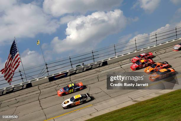 Dale Jarrett, driver of the UPS Ford, leads Jeff Gordon, driver of the Dupont Chevrolet, during the NASCAR Nextel Cup Series UAW-Ford 500 on October...