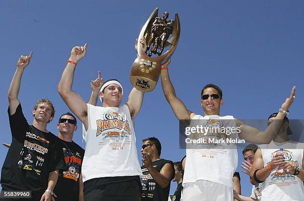 Robbie Farah and Benji Marshall of the Tigers present the NRL Premiership trophy to the crowd during the Wests Tigers Grand Final celebrations at...