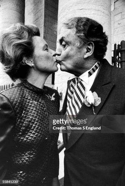 American political activist Phyllis Schlafly kisses her husband Fred at the wedding of one of their children, Alton, Illinois, 1981.