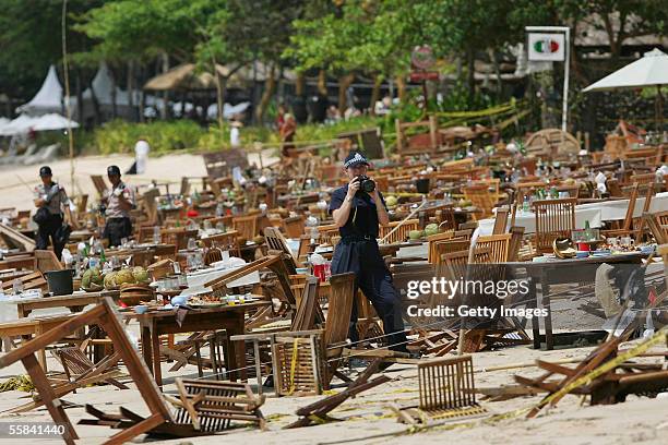 Australian Federal police and Indonesian Forensic collect evidence from the bomb site outside Nyoman Cafe on Jimbaran beach after it was attacked by...