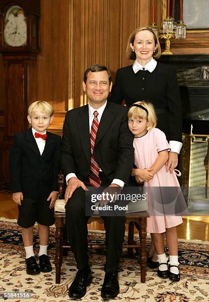 Chief Justice of the United States John Roberts sits for a photo with his family at the Supreme Court just before his investiture ceremony October 3,...