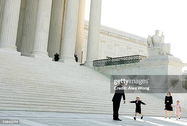 Supreme Court Chief Justice John G. Roberts leans forward as his son, Jack , runs toward him with open arms and wife, Jane, and daughter, Josie,...