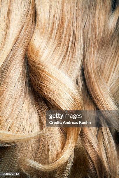 close up shot of wavy, blond hair. - blond model long hair foto e immagini stock