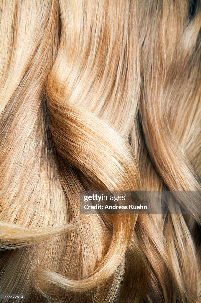 Close up shot of wavy, blond hair.