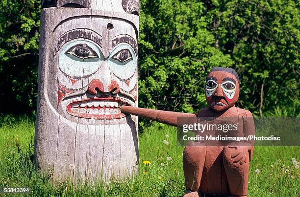 close-up of totem pole and a figure, ketchikan, alaska, usa - totem imagens e fotografias de stock