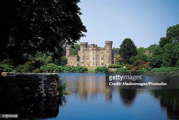 johnstown castle at a lakeside, county wexford, ireland - county wexford stock pictures, royalty-free photos & images