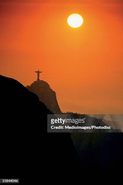 silhouette of statue of jesus christ at sunset, rio de janeiro, brazil - jesus christ photo stock pictures, royalty-free photos & images