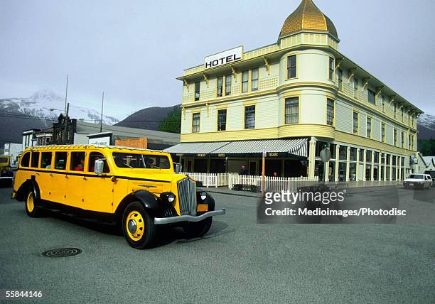 bus on a street, skagway, alaska, usa - alaska town mountains stock pictures, royalty-free photos & images