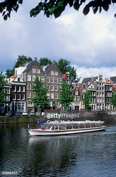 touring boat on a canal, netherlands - turistbåt bildbanksfoton och bilder