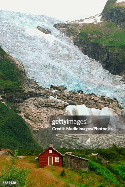 high angle view of a red house near a glacier, jostedalsbreen glacier, voss, hordaland, norway - voss stock pictures, royalty-free photos & images