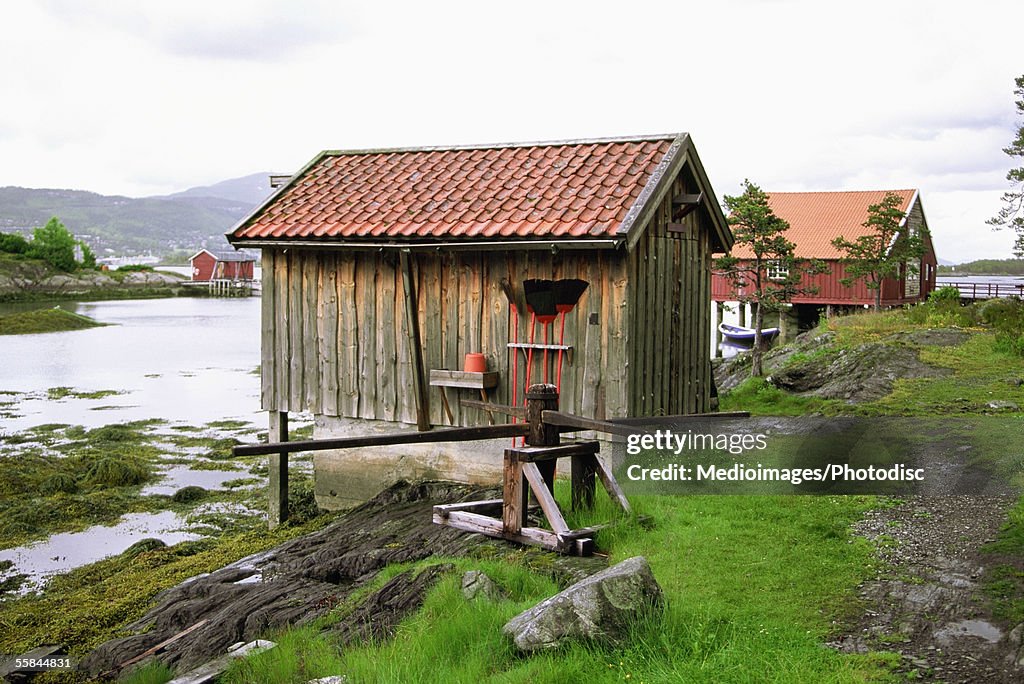 Norway, Molde, Hjertoya Island, Smoke house on the bank of a river