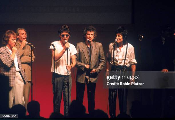 British rock and roll group the Rolling Stones answer questions from behind microphones at press conference at Grand Central Station to announce the...