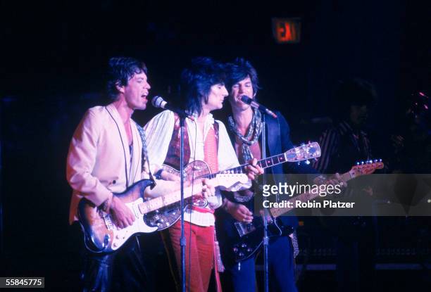 British rock and roll group the Rolling Stones perform on stage, 1980s. From left, Mick Jagger, Ronnie Wood, and Keith Richards all playing guitars.