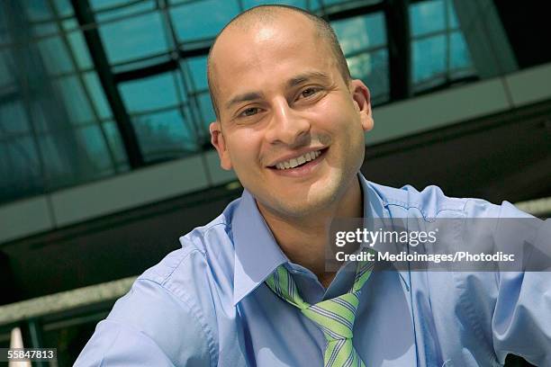 portrait of a mid adult businessman - shaved head stock pictures, royalty-free photos & images