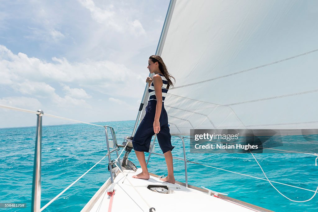 Woman standing at the bow of sailboat