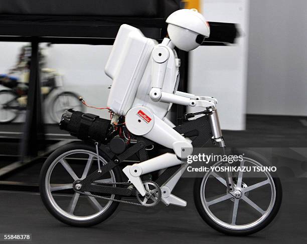 Japan's electronics parts maker Murata Manufacturing unveils the cycling robot "Murataseisaku-kun", as it speeds on the floor during the Ceatec,...