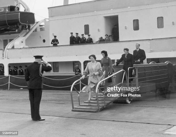 The Queen Mother and Princess Margaret step off the royal yacht Britannia at Portsmouth after saying goodbye to Prince Charles and Princess Anne,...