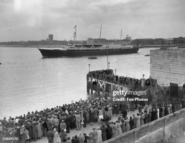 Crowd gathers to bid the royal yacht Britannia farewell upon her departure from Portsmouth, 14th April 1954. She is transporting Prince Charles and...