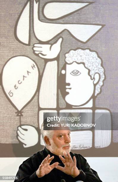Moscow, RUSSIAN FEDERATION: Famous French couturier Paco Rabanne gestures in front of the screen with internet reproduction of his picture devoted to...