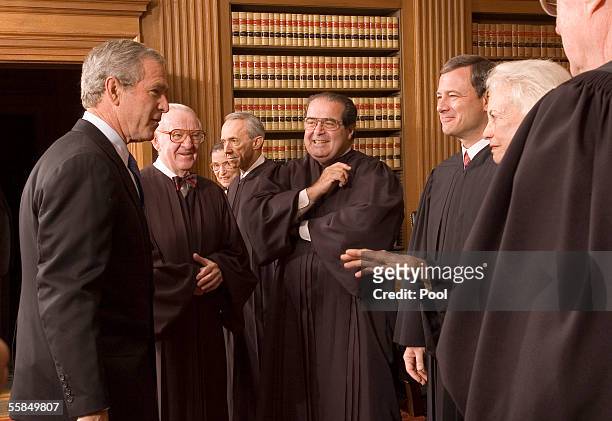 President George W. Bush enjoys a light moment with Supreme Court Justices , John Paul Stevens, Ruth Bader Ginsburg, David H. Souter, Antonin Scalia,...