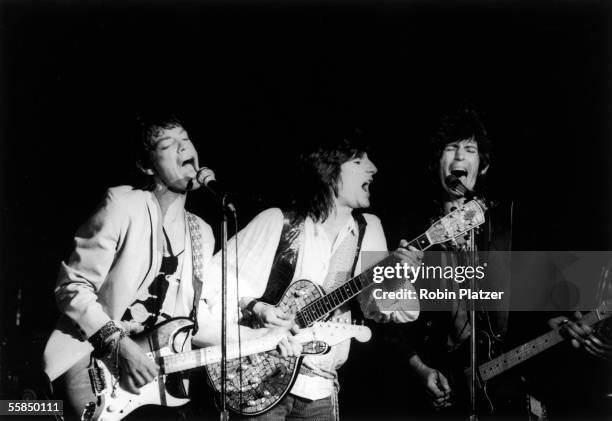 British rock and roll group the Rolling Stones perform on stage, 1980s. Pictured are, from left, singer and guitarist Mick Jagger, and guitarists...