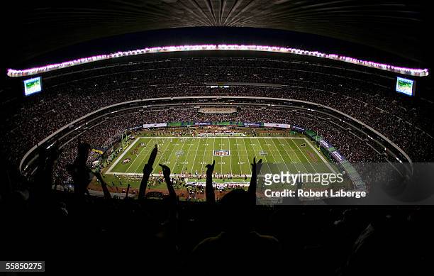 The fans cheer as the San Francisco 49ers score their first touchdown during the NFL game against the Arizona Cardinals at Estadio Azteca in Mexico...