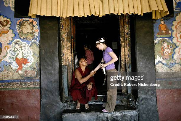 Ladakhi Buddhist monk greets a British tourist inside the Thiksey Monastery on August 5, 2005 in Thiksey, Ladakh, India. Thiksey, a popular monastery...