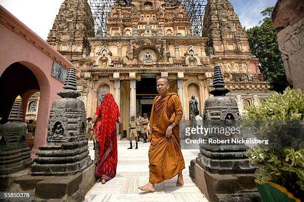 Thai Buddhist monk walks out the entrance where the Bodhi Tree lies at the Mahabodhi Temple on July 25, 2005 in Bodhgaya, India. It was underneath...